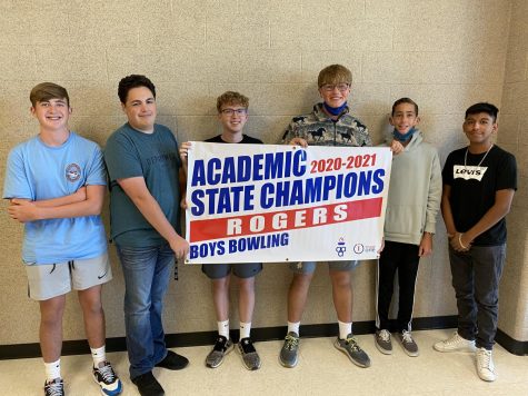 The rogers high school mens bowling team flexing their sign after receiving All Academic State Champions for bowling. The highly educated team has a average GPA of 3.63.