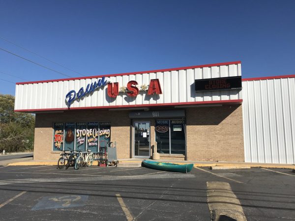 Pawn shop in downtown Rogers openly advertises their sale of guns.