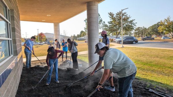 Student volunteers work diligently to complete the pollinator's garden.
Photo | Kayla Lester