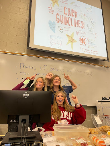 Letters of Love officers show off card guidelines to kick off a meeting in the Lecture Hall.