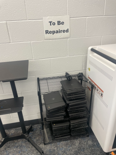 Chromebooks are piling up on the repair rack in the library.